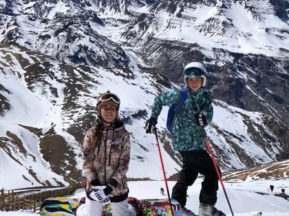 Two skiers on a snowy ridge