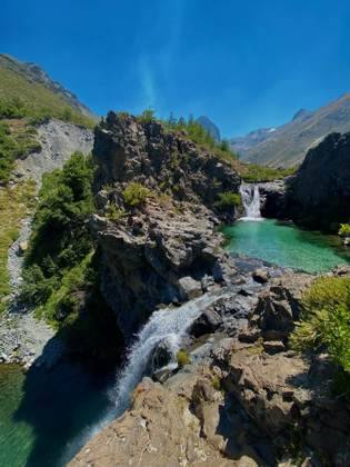 A turquoise waterfall in native forest